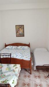 a bedroom with a bed and two chairs at Home to rent-Casa vacanza-Shtepi pushimesh-KONDAJ in Orikum
