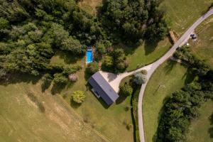 an overhead view of a farm with a blue barn at Domaine du Chypre in Cercier