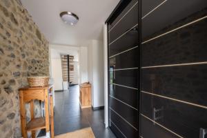 a hallway with a large black closet in a house at Domaine du Chypre in Cercier