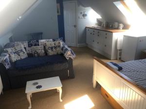 uma sala de estar com um sofá e uma cama em Porthcawl, Nr Sea & Centre. Private guest suite. em Porthcawl