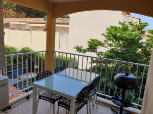 a table and chairs on the balcony of a building at Appartement vacances cap d’agde in Cap d'Agde