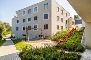 an apartment with a playground in front of a building at Willhelm - Hauff in Engen