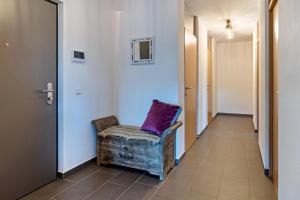 a hallway with a chair with a purple pillow on it at Willhelm - Hauff in Engen
