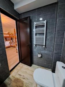 a bathroom with a toilet and a sink and a window at Galasha in Mestia