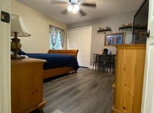 a bedroom with a bed and a ceiling fan at A Treasure Coast Gem. in Port Saint Lucie