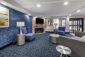 a living room with a couch and chairs and a fireplace at Best Western Bloomington Edina - Minneapolis in Bloomington