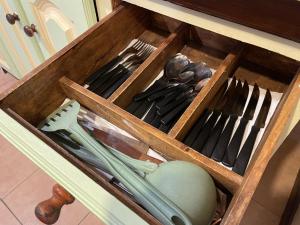 a wooden drawer filled with forks and knives at La Comarca Azul in El Calafate