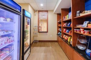 a store aisle with a refrigerator and shelves of food at Hampton Inn Ringgold-Ft. Oglethorpe in Ringgold