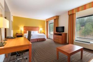 a hotel room with a bed and a desk at Hampton Inn Ringgold-Ft. Oglethorpe in Ringgold