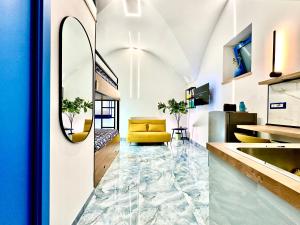 a living room with a yellow couch and a mirror at Linea1 Amalfi Coast 500 Mt Beach in Maiori