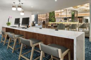 a lobby with a bar with chairs and a waiting area at Hilton Grand Vacations Club Chicago Magnificent Mile in Chicago
