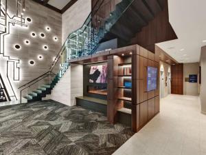 a large lobby with a staircase and a display case at Hampton Inn & Suites Chicago-Downtown in Chicago