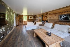 sala de estar con sofá y mesa de madera en Chalet le Bois de Cerf en Le Bouchet-Mont Charvin