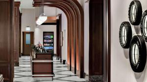 a hallway with clocks on the wall in a hotel at Home2 Suites By Hilton Chicago McCormick Place in Chicago