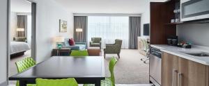 a hotel room with a kitchen and a living room at Home2 Suites By Hilton Chicago McCormick Place in Chicago