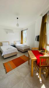 a living room with two beds and a table at Kaş Centre -The Rush Apart-1 in Kas +17 photos