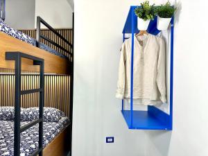 a blue shelf next to a staircase with a white shirt at Linea1 Amalfi Coast 500 Mt Beach in Maiori