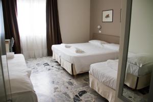Postel nebo postele na pokoji v ubytování Hotel Arianna