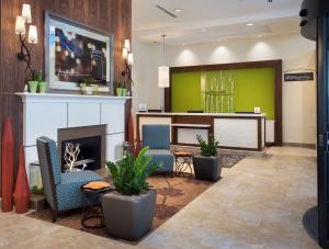 a lobby with chairs and a fireplace in a hotel at Hilton Garden Inn Chicago Downtown Riverwalk in Chicago