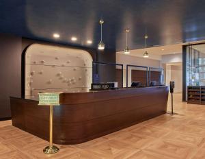 a reception desk with a sign in front of it at Sable At Navy Pier Chicago, Curio Collection By Hilton in Chicago