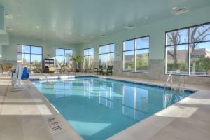 a large swimming pool with blue water in a building at Hampton Inn & Suites by Hilton Chicago Schaumburg IL in Schaumburg