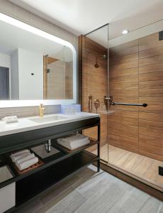 a bathroom with a sink and a shower at Sable At Navy Pier Chicago, Curio Collection By Hilton in Chicago