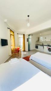 a large bedroom with two beds and a kitchen at Kaş Centre -The Rush Apart-1 in Kas