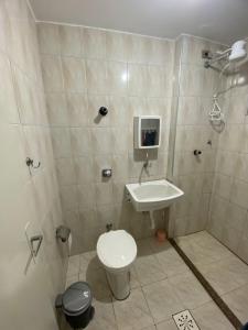 La salle de bains est pourvue de toilettes et d'un lavabo. dans l'établissement Lindo kit na quadra da praia, à Santos