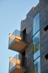 a building with balconies on the side of it at Glass House - Smart Rooms & Parking in Lecce