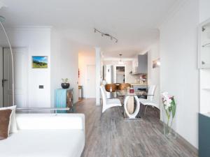 a living room with a white couch and a table at Live Tabaiba Maritime Avenue con vista del mar in Tabaiba