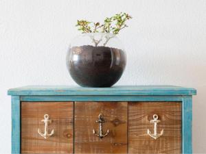 a vase on top of a wooden cabinet with a plant in it at Live Tabaiba Maritime Avenue con vista del mar in Tabaiba