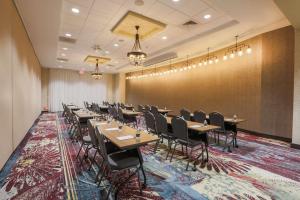 a conference room with tables and chairs on a rug at Homewood Suites By Hilton Charleston Historic District in Charleston