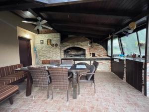 a kitchen with a table and chairs and a brick oven at Holiday Home Ajaz Bihac in Bihać