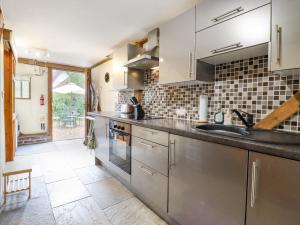 a kitchen with a sink and a counter at The Studio, Horseshoe Cottage in Fulbourn