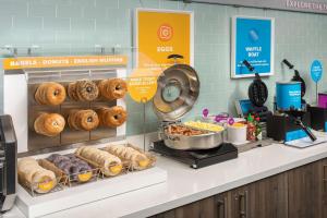 a bakery with donuts and pastries on a counter at Tru By Hilton Charleston Ashley Phosphate, Sc in Charleston