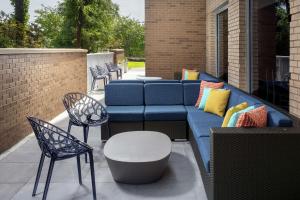 a blue couch and chairs on a patio at Tru By Hilton Mt Pleasant Charleston in Charleston