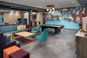 a lobby with a pool table and a large mural at Tru By Hilton Mt Pleasant Charleston in Charleston