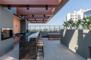 a view from the roof of a building with tables and benches at LIV - Apartamento 1011 in Porto Alegre