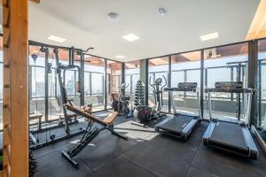 a gym with treadmills and elliptical machines at LIV - Apartamento 1011 in Porto Alegre