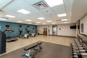 a gym with several treadmills and machines in it at Hampton Inn Madison, OH in Madison