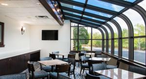 a restaurant with tables and chairs and a large window at Hampton Inn Cleveland-Solon in Solon