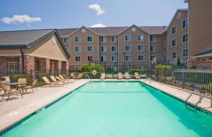 a swimming pool in front of a building at Homewood Suites by Hilton College Station in College Station