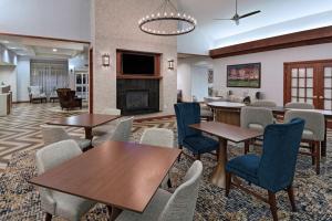 a lobby with tables and chairs and a fireplace at Homewood Suites by Hilton College Station in College Station