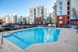 a swimming pool in an apartment complex with buildings at Hampton Inn College Station-Near Texas A&M University in College Station