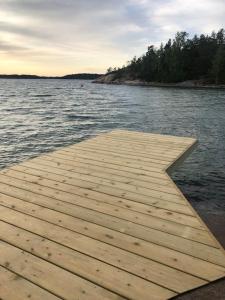 a wooden dock in the middle of a body of water at Klippan - mökki omalla rannalla Nauvossa in Nauvo +4 photos