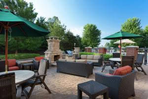 a patio with tables and chairs and a fire place at Hampton Inn Belmont at Montcross in Belmont