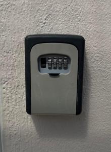 a remote control attached to a white wall at Póe home Trikala in Tríkala