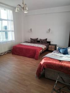 a room with two beds with red sheets in it at Вілла Сади Єви in Lyubintsy