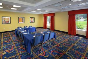 a banquet room with blue tables and chairs on a carpet at Hampton Inn & Suites Huntersville in Huntersville +42 photos