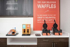 a counter with a display of various products on it at Hampton Inn & Suites Charlotte Airport Lake Pointe in Charlotte